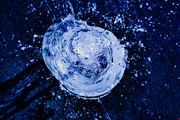 Water jet going up towards the camera, blue tones, background for hydrological concept.