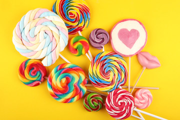 Fototapeta na wymiar lolly candies with sugar. colorful array of childs lollipops sweets and treats with candy