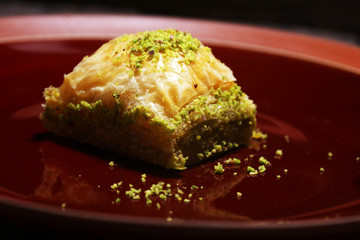 Middle eastern or arabic dishes. Turkish Dessert Baklava with pistachio on dishes