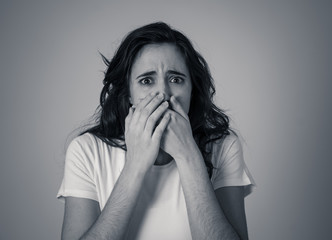 Portrait of a young attractive woman looking scared and shocked. Human expressions and emotions