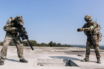 United States army in action, camouflage and army helmet. Rifle shooting. Storming a military base...