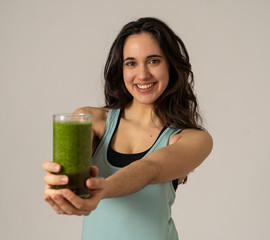 Beautiful fit sport latin woman drinking healthy fresh vegetable smoothie feeling great and healthy