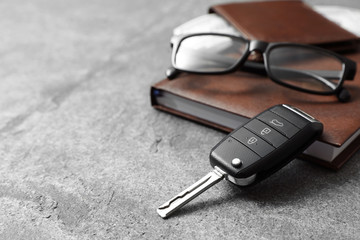 Composition with male accessories and car key on grey background. Space for text