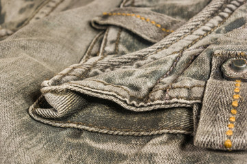 clothing items washed cotton fabric texture with seams, clasps, buttons and rivets
