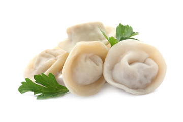 Pile of boiled dumplings with parsley leaves on white background