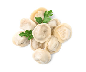Pile of boiled dumplings with parsley leaves on white background, top view