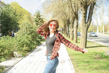 Happy girl walks down the street in spring around the city