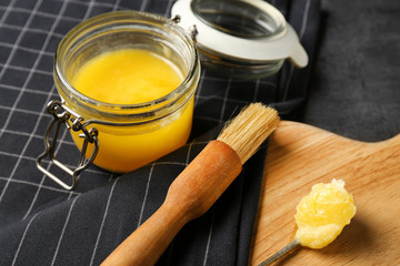 Composition with clarified butter and basting brush on table