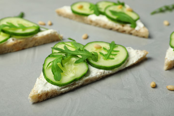 Traditional English cucumber sandwiches on grey table