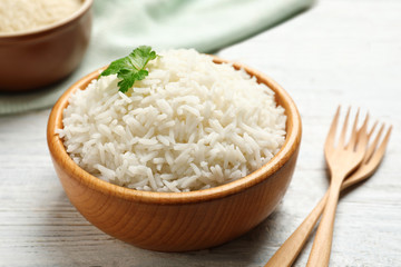 Bowl of tasty cooked rice served on table