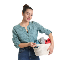 Happy young woman holding basket with laundry on white background