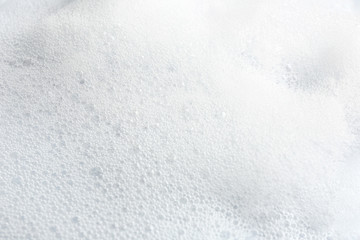 Soft white soap foam as background, closeup