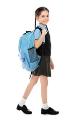 Full length portrait of cute girl in school uniform with backpack on white background