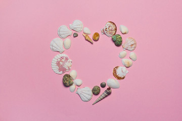  heart of seashells. seashells on a pink background with space for text