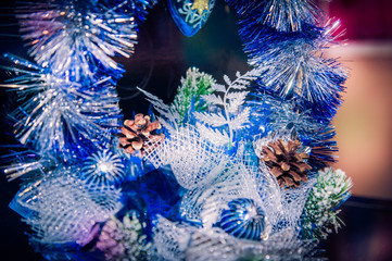Fototapeta na wymiar Christmas decoration of blue and silver garland with pine cones