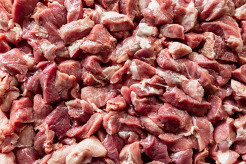 Heap of raw diced beef meat isolated, top view