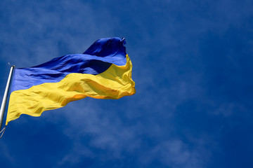 Large national flag of Ukraine in the blue sky. Big yellow blue Ukrainian state flag in the Dnepr city, Dnepropetrovsk, Spring, Summer, Autumn
