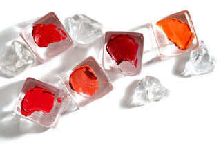 Red and orange lipstick swatches.