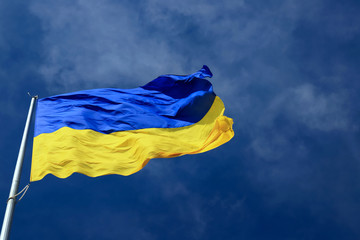 Large national flag of Ukraine in the blue sky. Big yellow blue Ukrainian state flag in Dnepr city, Dnepropetrovsk, Spring, Summer, Autumn