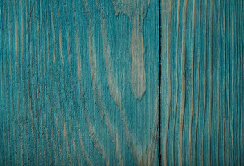 Fototapeta na wymiar The background texture of painted wood. Top view on the texture of a blue-green wooden board with vertical lines. A cropped shot, horizontal, close-up, no one. The concept of construction and design.