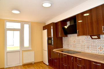 Premises of kitchen with the built-in furniture and a balcony door
