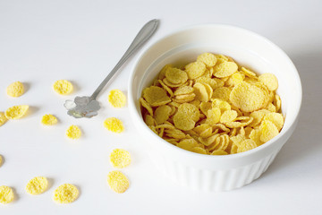 Healthy breakfast with cornflakes and milk over white background