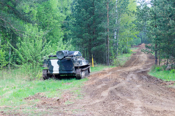 Fototapeta premium forest. worth infantry fighting vehicle. road share of military equipment. have toning