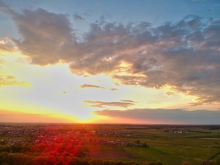 Fototapeta na wymiar sunset over green field in Minsk Region of Belarus