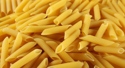  Penne rigate pasta pile background and texture, side view
