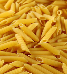  Penne rigate pasta pile background and texture, side view