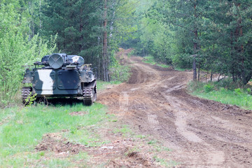 Fototapeta premium forest. worth infantry fighting vehicle. road share of military equipment. have toning