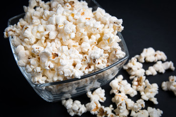 popcorn in a glass bowl on a black background