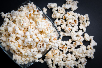 popcorn in a glass bowl on a black background