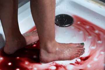 cropped view of barefoot bleeding woman in bathroom