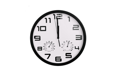  simple classic black and white round wall clock isolated on white. Clock with arabic numerals on wall shows 12:00