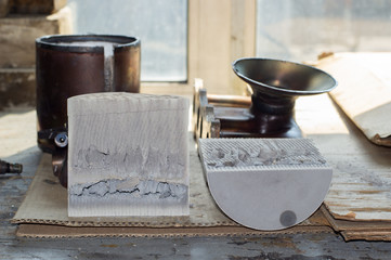 The catalytic converter of the exhaust gases of the car, melted from the inside, is disassembled and cut into two parts