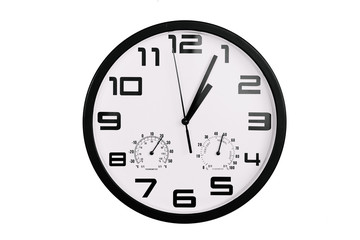 simple classic black and white round wall clock isolated on white. Clock with arabic numerals on wall shows 1:05 , 13:05