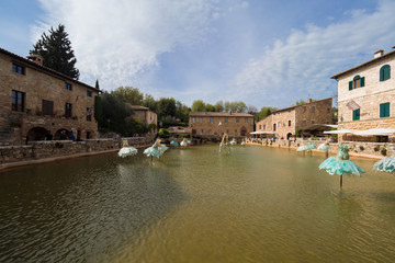 Fototapeta na wymiar Bagno Vignoni. A natural pool in the middle of the houses of a village in Tuscany.