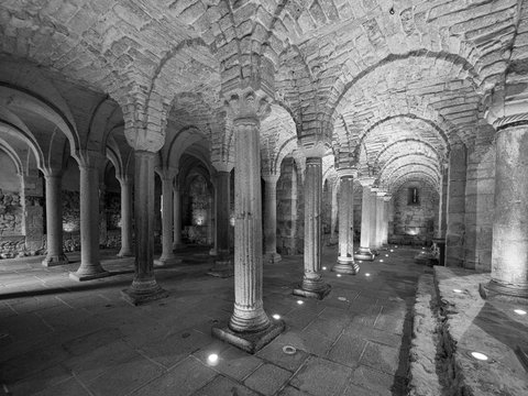 Crypt of a medieval abbey with carved stone columns.