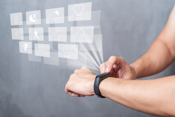 A Sport man is using smart band with virtual screen device