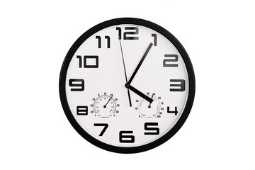 simple classic black and white round wall clock isolated on white. Clock with arabic numerals on wall shows 16:05 , 4:05