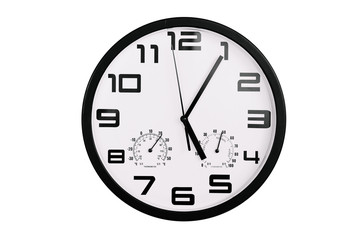 simple classic black and white round wall clock isolated on white. Clock with arabic numerals on wall shows 17:05 , 5:05