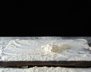  white wheat flour on a wooden brown board