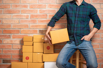 A man entrepreneur owner SME business is packaging box to send his customer