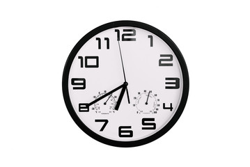 simple classic black and white round wall clock isolated on white. Clock with arabic numerals on wall shows 18:40 , 6:40