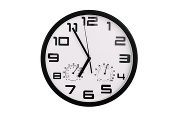 simple classic black and white round wall clock isolated on white. Clock with arabic numerals on wall shows 18:55 , 6:55