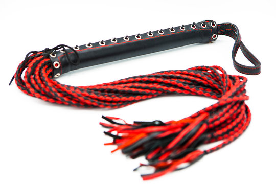 Leather whip isolated on white background. Sex toy for intimate perversions. Sex slavery.	
