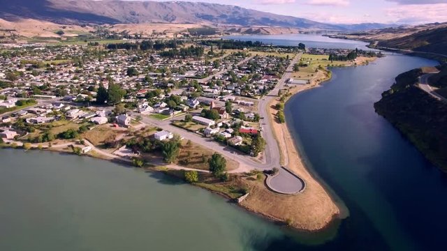 Aerial footage of Cromwell, picturesque town in New Zealand in between river and lake.