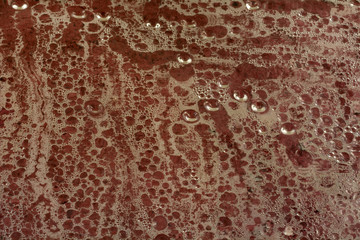 Close up of water condensation and water droplets on red purple background