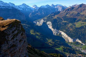 Aerial view to mountain peaks over Lauterbrunnen valley and alpine village Wengen Switzerland.